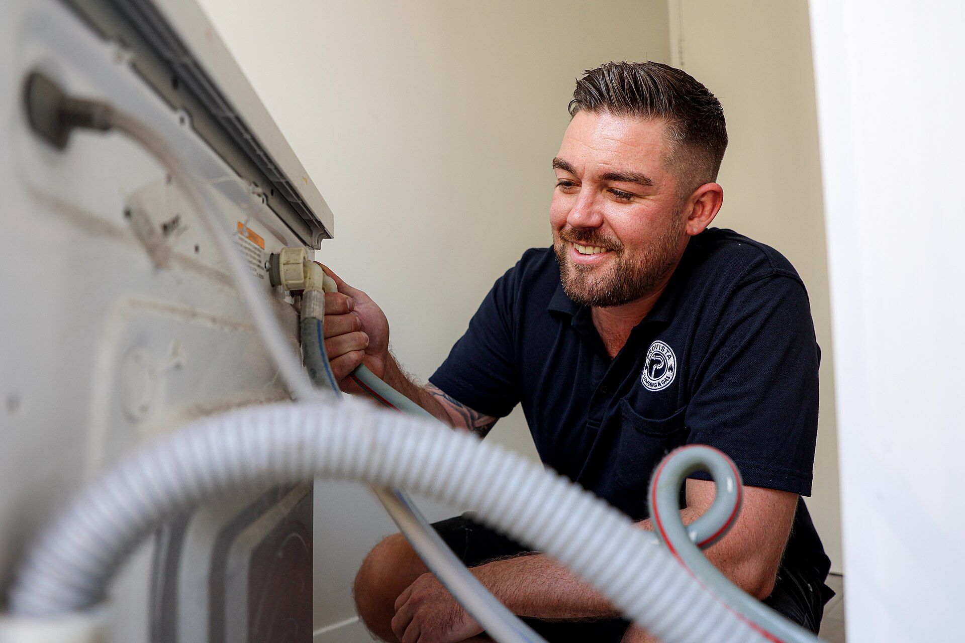 Plumber working on a residential appliance connection