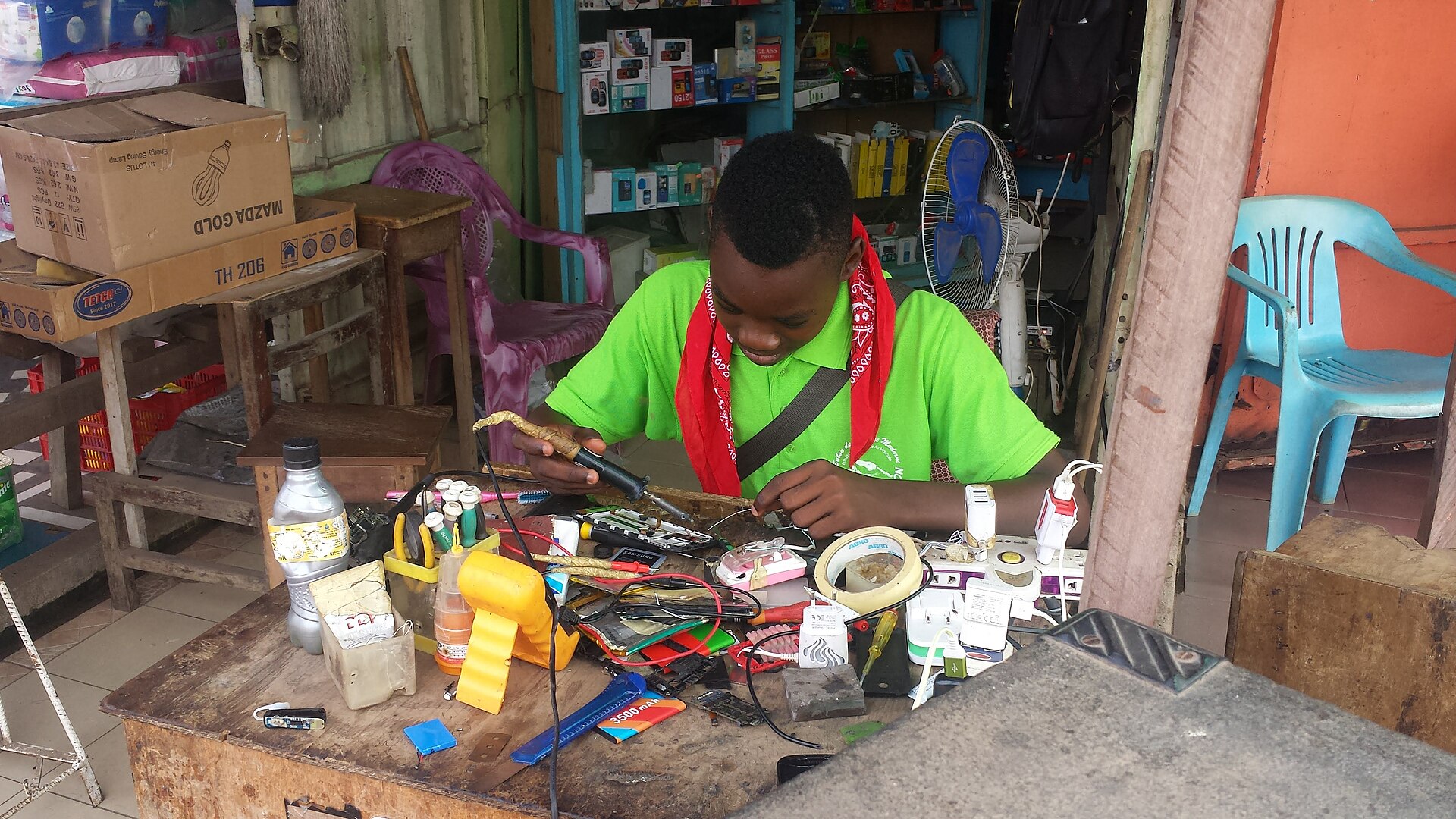 Independent repair technician working with electronic components in his workshop